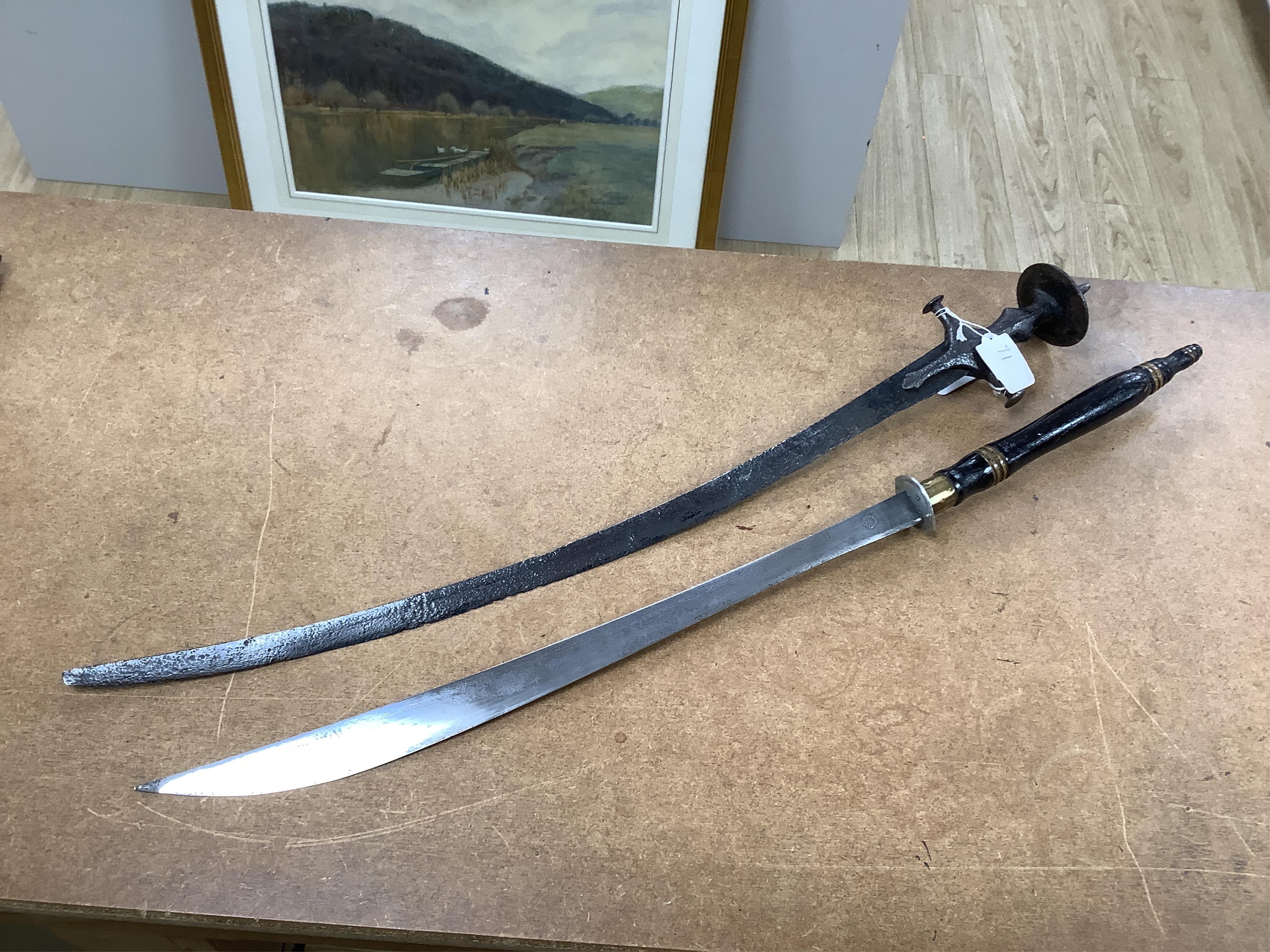 Four bladed weapons; an Indian sword Tulwar, blade 68.5cm. Condition - poor, heavily pitted., A Nepalese Kukri. Condition - fair., A Thai sword Dha, with a lacquered hilt and wooden scabbard, blade 56cm. Condition - fair